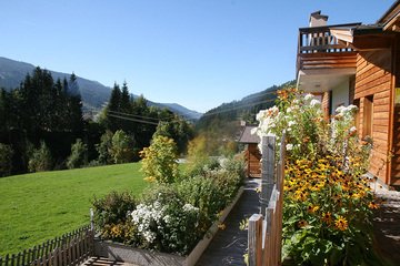 View from the sun terrace by the communal pool at the Alpin Chalets XL in Wagrain.