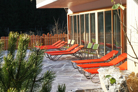 Saunaterrasse mit Liegestühlen beim Alpin Chalet Large in Filzmoos.